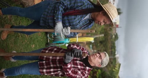 Women Gardening Together Outdoors on Rural Land
