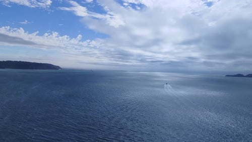 Boat Moving Across Open Ocean Water