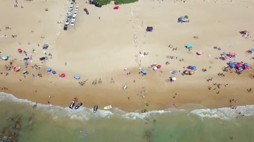 Mediterranean beach during summer with people in the water