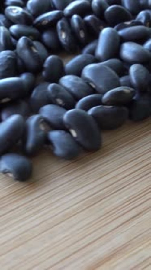 Pile of Black Beans on Tan Surface