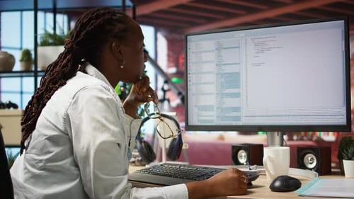 Woman Works at Her Computer in Office
