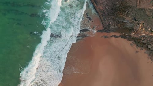 Aerial Frothy Waves Washing Sandy Beach Green Ocean Waters Contrast Shore