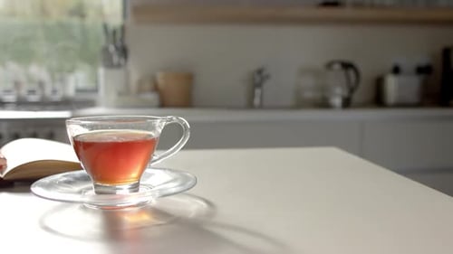 Eine Tasse Tee steht im Fokus auf einem Tisch mit Kopierraum