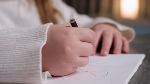 Close Up of School Girl Hands Holding Purple Pencil Drawing Shapes on Paper