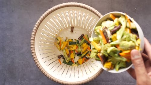 Vegetable Scraps Poured Into Compost Bin