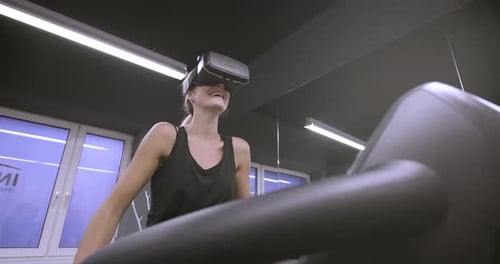 Woman uses VR on Treadmill at the Gym
