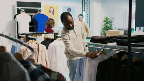Modern Man Shopping for Formal Wear in Clothing Store