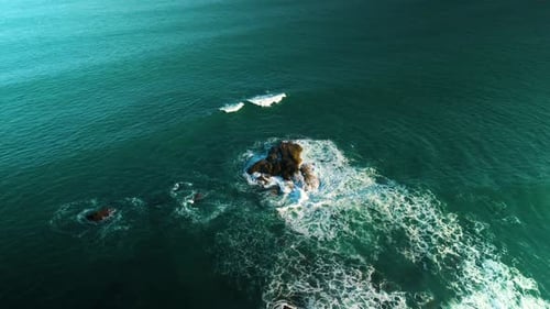 Aerial Perspective Revealing Powerful Ocean Waves Striking Rocky Coastline Generating White Foaming
