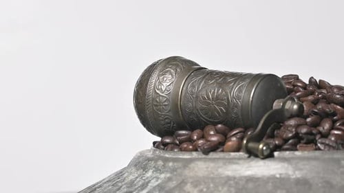 Plates Full Of Roasted Coffee Beans Sliding In Front Of The White Background