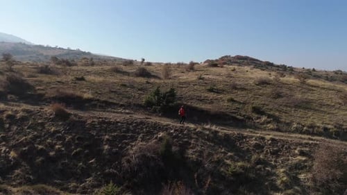 Aerial View Young hiker walking on a mountain path on a sunny day