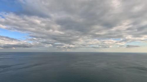 Timelapse Fluffy Cumulus Clouds Moving in Bright Sunset Sky Over Calm Sea Abstract Aerial Nature