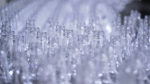 Bottles on Conveyor Belt in Factory. Bottle Manufacturing Technology in Industrial Factory