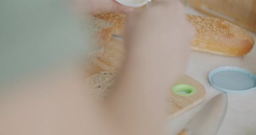 Spreading Cream Cheese on Bread for Sandwich