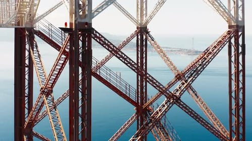 Aerial View of High Voltage Big Pylon Structure Near the Ocean