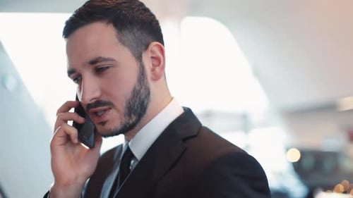 Man in Suit Talking on Phone in Office