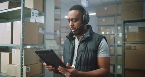 Warehouse Worker Uses Tablet in Distribution Center