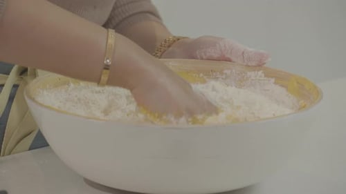 mixing dough with hands. video preparation for making cakes and bread. footage of activities in the
