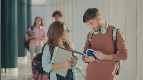 Two Attractive Students Talk at High School College Hall