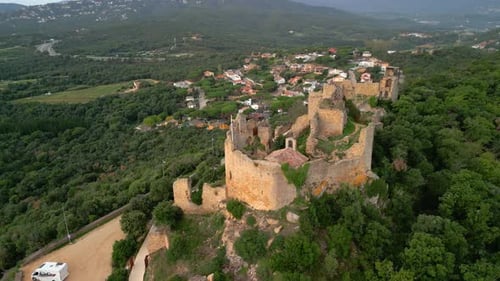 Ruined castle in Europe aerial footage cinematic medieval era Aerial image with motorhome in the Pal