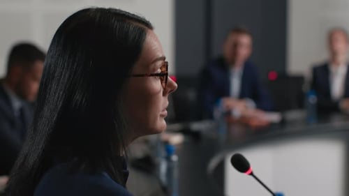 Confident businesswoman delivers political speech at convention hall meeting