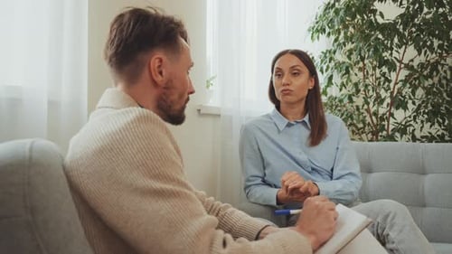 Woman Talks to Man in Office Setting