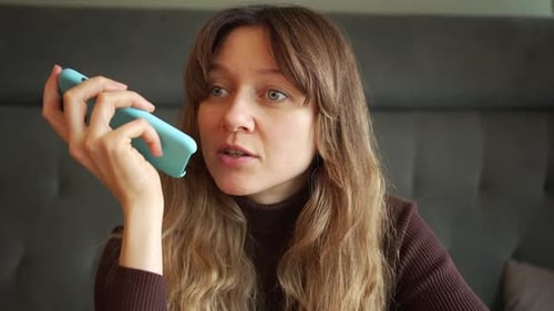 Woman Talking on Phone Inside