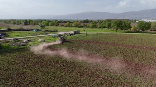 Top View of Tractor Sowing Grain in the Farm Field