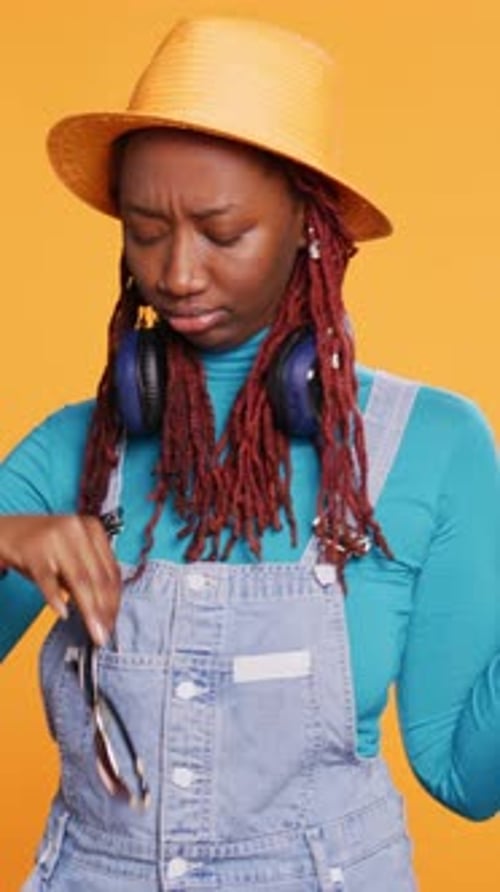 Stylish Young Adult Posing With Sunglasses and Headphones