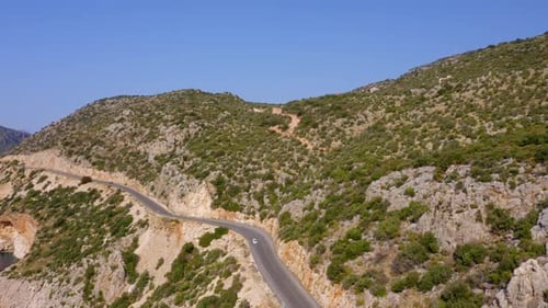 Aerial Drone View of Mountain Road with Driving Cars and Tropical Island