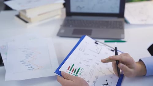 Businessperson Analyzes Data at Desk