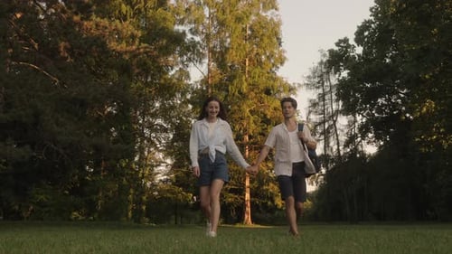 Couple Holding Hands Walking In Park