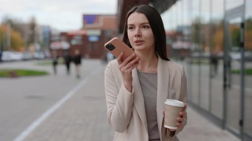 Woman Using Voice Command App While Walking