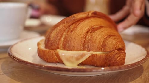 Golden Croissant Sandwich with Melting Cheese Close Up