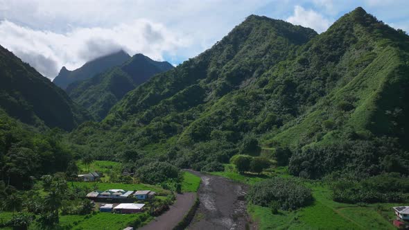 Towering mountain volcano peaks valley rivers Teahupoo town Tahiti ...