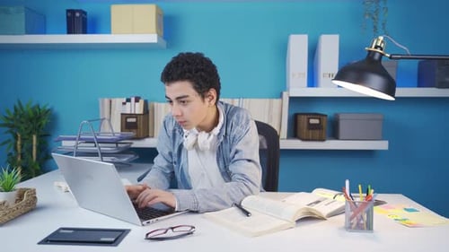 Young male student studying at a fast pace.