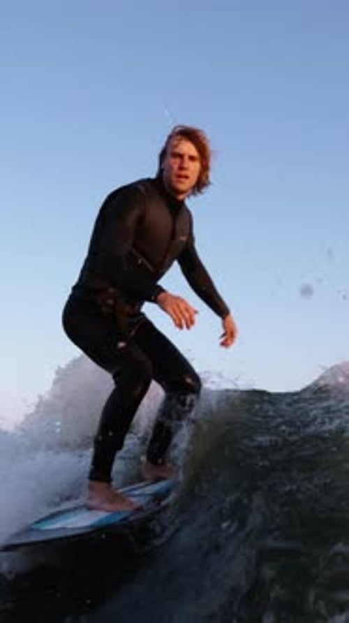 Surfer Riding the Waves at Sunset A Dynamic Display of Balance and Skill on the Water with a