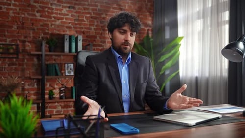 Professional Businessman in Modern Office Setting Discussing Work