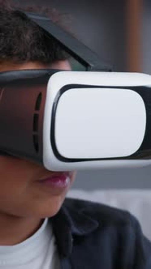 Young Boy Experiences Virtual Reality with VR Headset