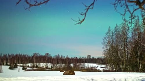 Stars And Northern Lights In The Night Sky Over Snowy Landscape In Winter. timelapse