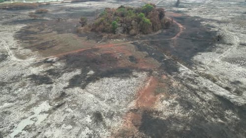 A large area of land is covered in ash and dirt