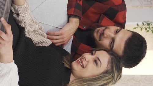 Happy Couple Relaxing at Home with Laptop