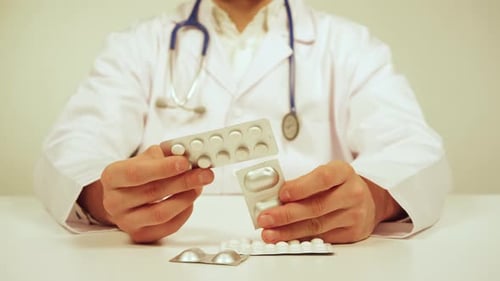 Doctor with Pills in Blister Packs
