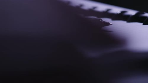 Cinematic Close-up of a Fountain Pen on a Spiral Notebook