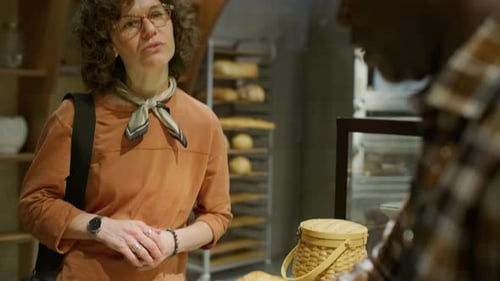 Woman Buying Fresh Croissants while Visiting Bakery