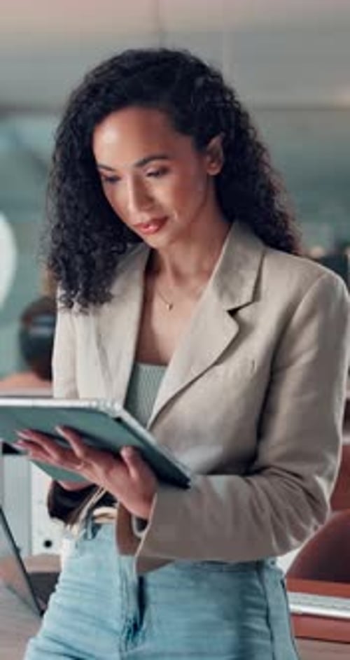 Woman, tablet and thinking at startup, office and typing with review for project at media company