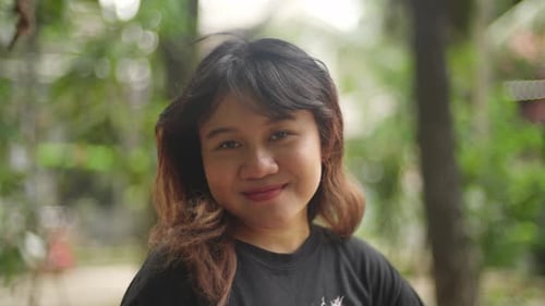 Indonesian girl smiling brightly at the camera