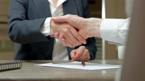 Business People shaking hands over contract