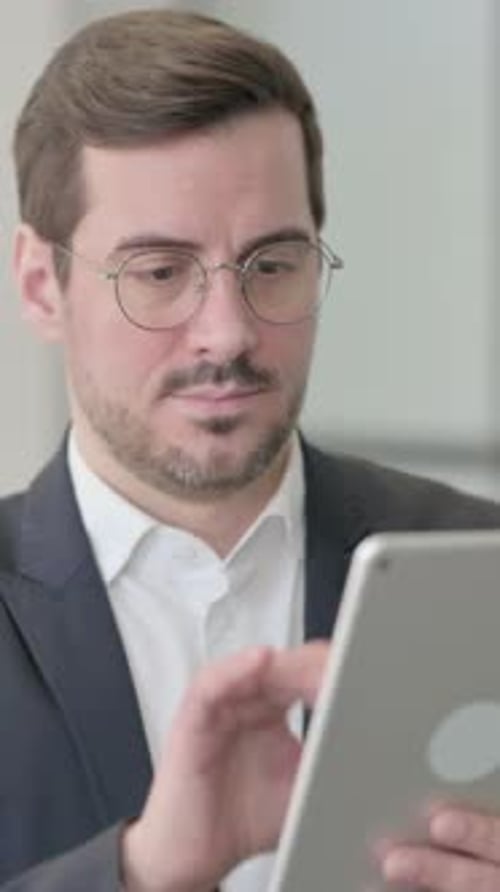 Man in Suit Using Tablet Close-Up
