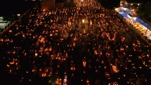 Flying over a well lit cemetery during day of the dead in Mexico