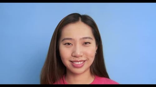 Young Adult Opens Eyes and Smiles in Studio